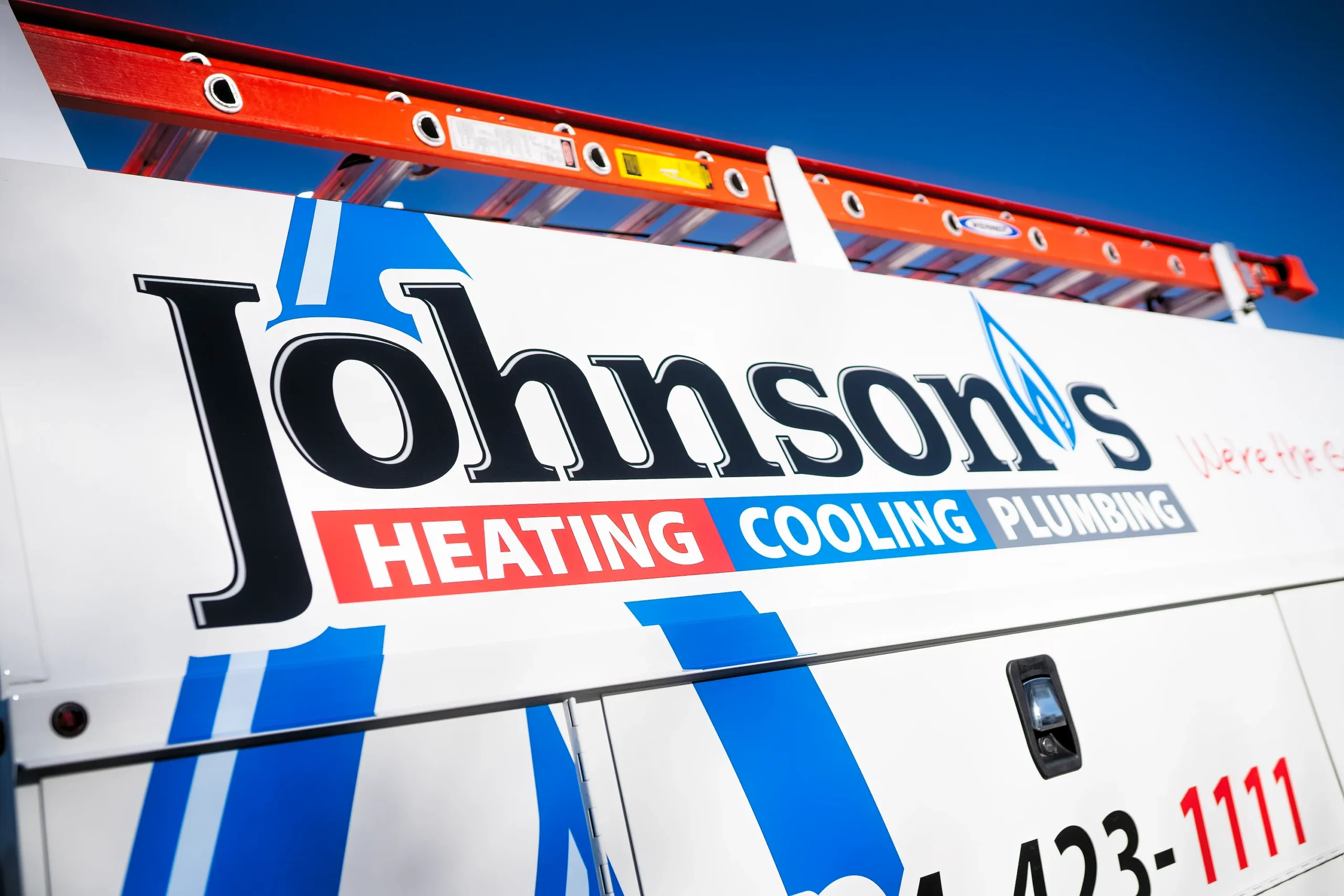 Johnson's Heating & Cooling Experts work truck with ladder